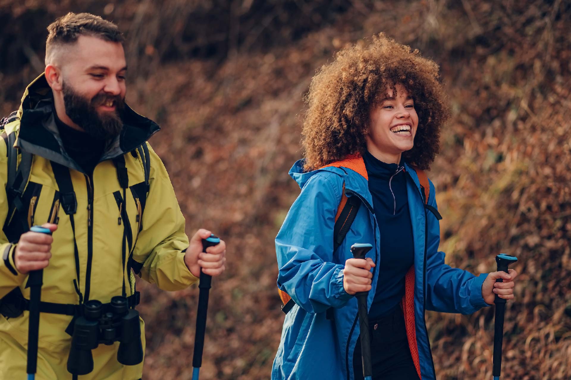 Ein Mann und eine Frau gehen gemeinsam auf einem Bergpfad während einer Outdoor-Sportaktivität in der Natur